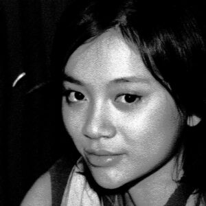 Portrait of a model identified as Xenia J., age 26, from Cedar Rapids, IA. Black and white, stylized.